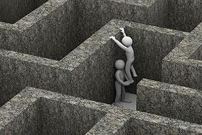 person being lifted out of a maze by another person